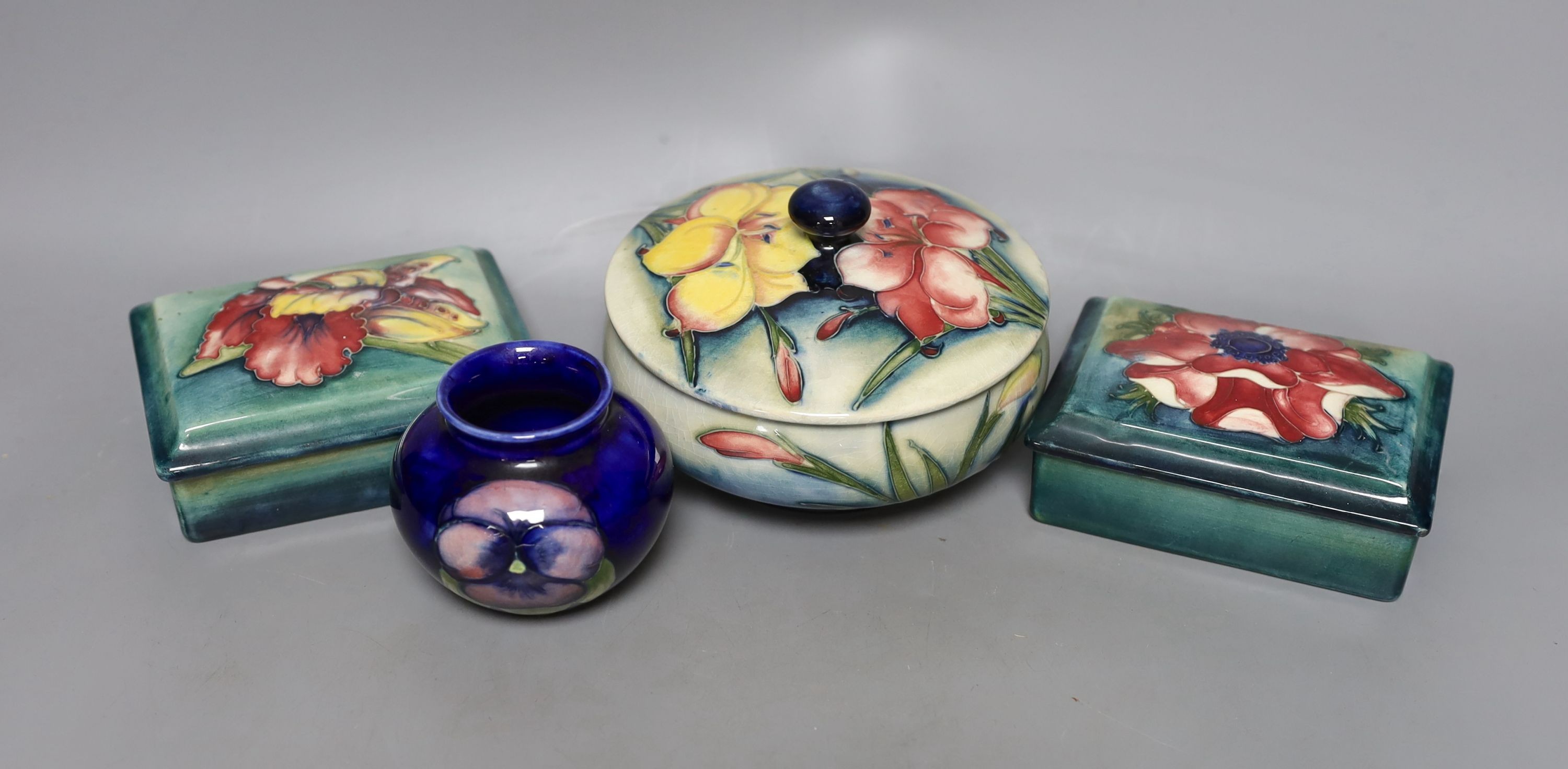A pair of Moorcroft boxes with covers, together two other moorcroft pots (4)